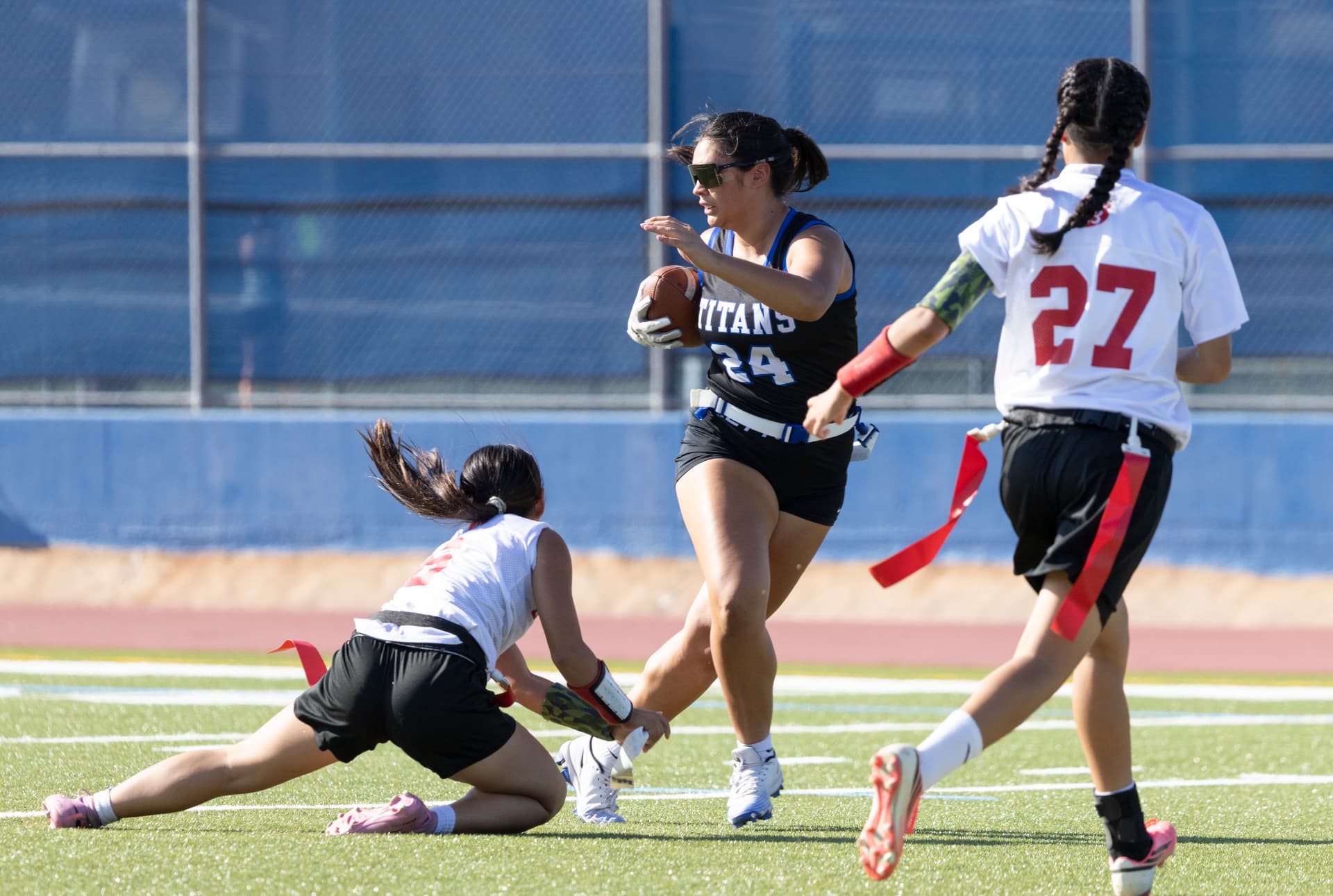 Titans No. 24 sprints past a diving flag pull on a long run down the sideline.