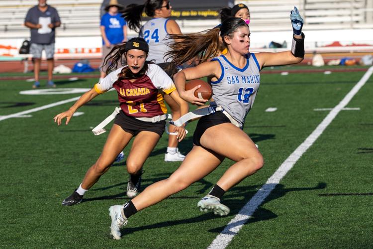 Kaia Kooper carries the football into the open field as a La Cañada defender gives chase.