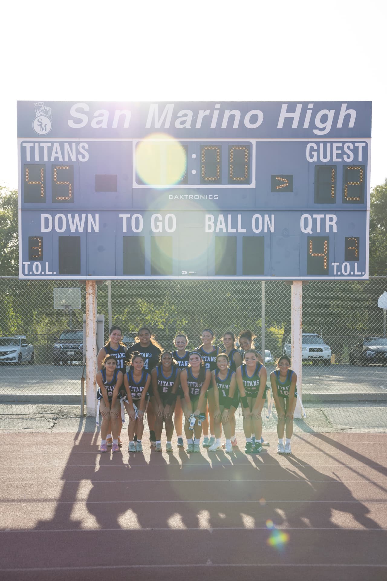 The Titans gather under the San Marino High scoreboard to celebrate a 45-12 home victory.